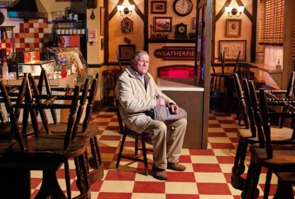 Coronation Street photo of a sullen Roy Cropper sitting in his cafe alone at night