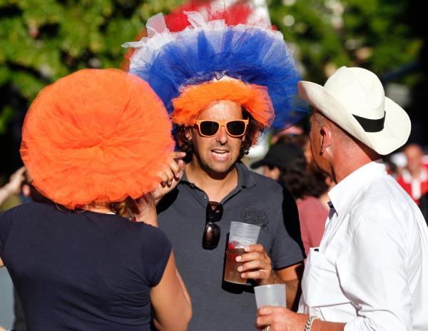 French tennis fans drinking and wearing colorful hats