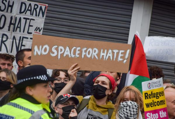 Protester holds a home-made sign reading "No space for hate!"