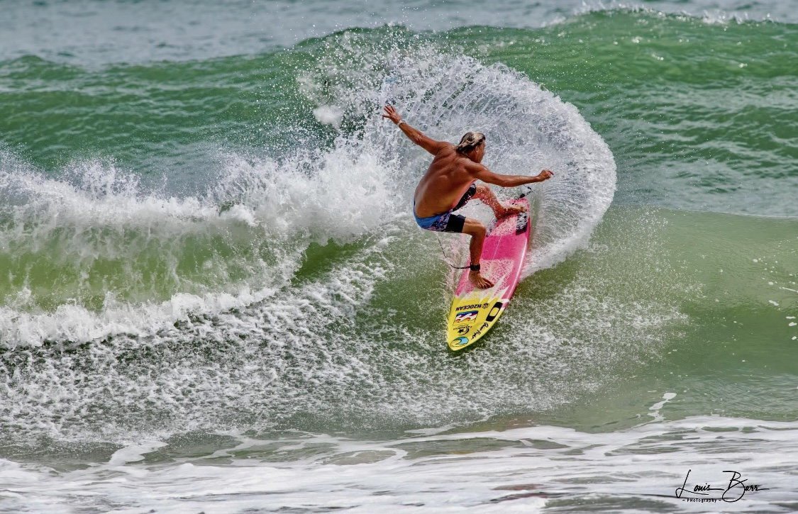 Charley Hajek surfs a wave at New Smyrna Beach, Florida