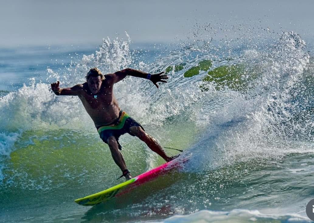 Charley Hajek surfs a wave at New Smyrna Beach, Florida