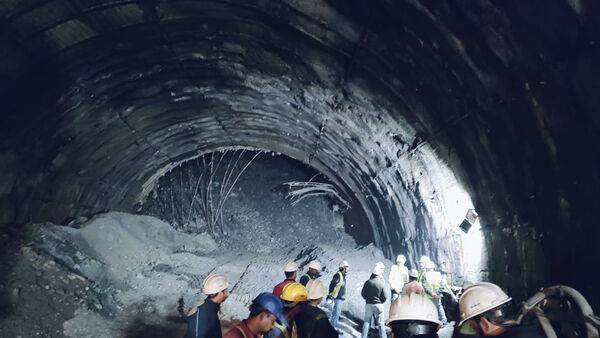 Rescuers dig to reach 40 workers trapped in collapsed road tunnel in India