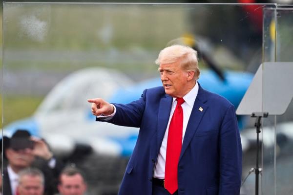Former US President and Republican presidential candidate Donald Trump points after speaking about national security during a campaign rally at the North Carolina Aviation Museum & Hall of Fame in Asheboro, North Carolina, August 21, 2024.