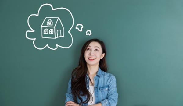 A woman thinking about owning her own property with a thought bubble concept. 
