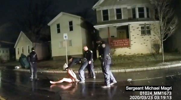 This image shows a Rochester, N.Y., police officer as he puts a hood over the head of Daniel Prude. Prude died after police held him down until he stopped breathing.