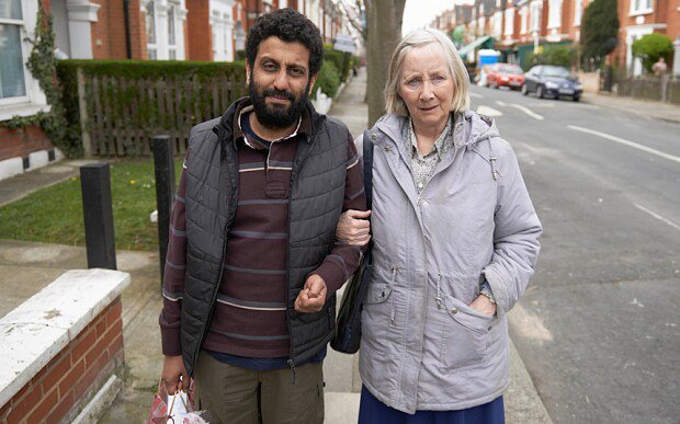 Adeel Akhtar and Gemma Jones standing on a sidewalk in a scene from Capital.