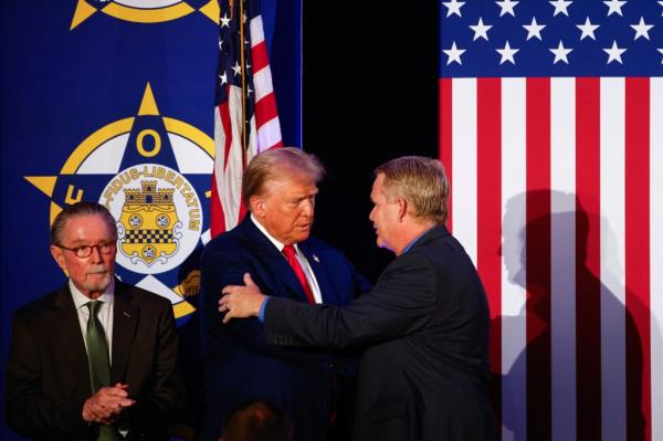 Republican presidential nominee and former U.S. President Donald Trump is greeted as he attends a meeting with the Fraternal Order of Police in Charlotte, North Carolina, U.S. September 6, 2024.