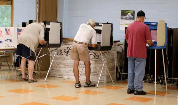 People cast their ballots at the Peace UCC poll during the primary election, Tuesday, August 13, 2024, in Manitowoc, Wis.