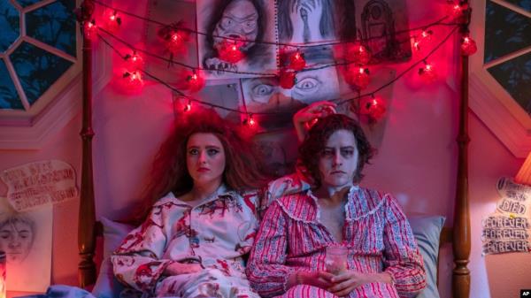 This image released by Focus Features shows Kathryn Newton, left, and Cole Sprouse in a scene from "Lisa Frankenstein." (Michele K. Short/Focus Features via AP)