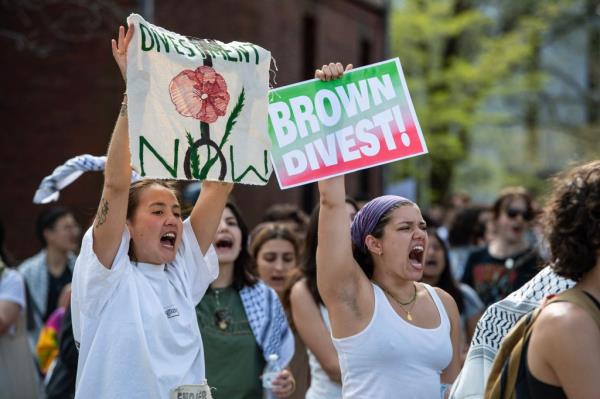 Pro-Palestinian protestors rally as they march around university hall at the pro-Palestinian encampment at Brown University as they await answers from their delegation who are meeting with school leaders on campus in Providence, Rhode Island, on April 29, 2024.
