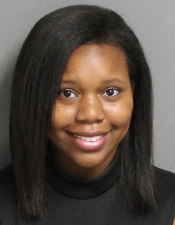 Carlee Russell smiled in her mugshot after she admitted to faking her own kidnapping.