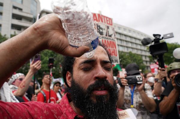 Protester rinsing eyes with water after being pepper sprayed during a pro-Palestinian demonstration on Capitol Hill, Washington, U.S., July 24, 2024