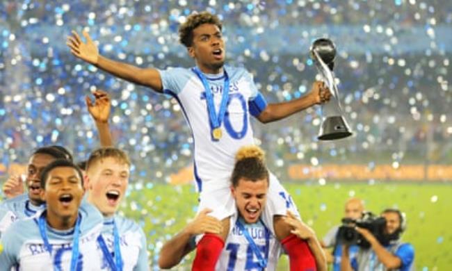 Gomes is lifted on to his teammates shoulders and holds the Under-17 World Cup trophy