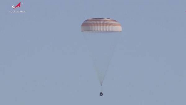 Capsule carrying record-breaking astronauts returns to Earth
