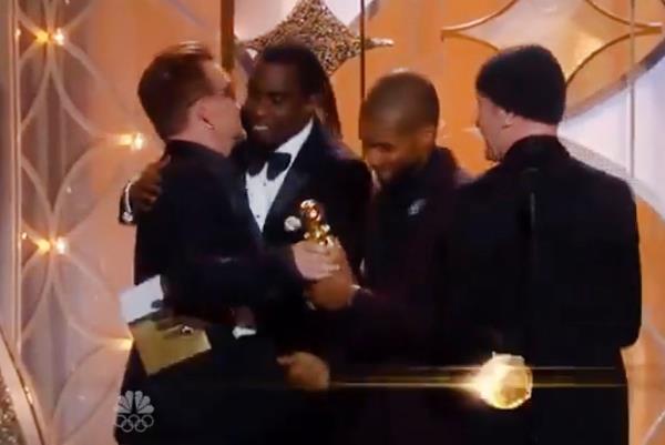 Diddy hugs Bono at the 2014 Golden Globe Awards