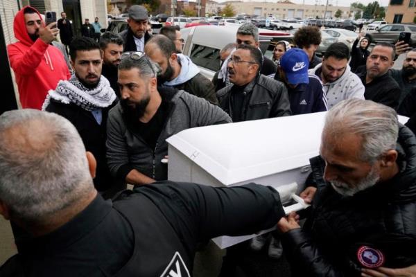 Family members of Wadea Al Fayoume bring his casket into Mosque Foundation in Bridgeview, Illinois, on 16 October 2023.