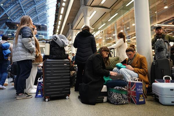 Passengers sit on the floor of the concourse at the entrance to Eurostar in St Pancras International station, central London, after high-speed services between London and Ebbsfleet were cancelled because of flooding in a tunnel under the Thames. Picture date: Saturday December 30, 2023. Picture: James Manning/PA Wire Passengers sit on the floor of the concourse at the entrance to Eurostar in St Pancras International station, central London, after high-speed services between London and Ebbsfleet were cancelled because of flooding in a tunnel under the Thames. Picture date: Saturday December 30, 2023. Picture: James Manning/PA Wire