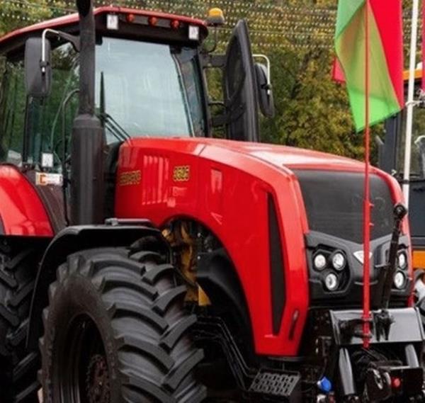 A big, shiny and red tractor given to Putin on his 70th birthday