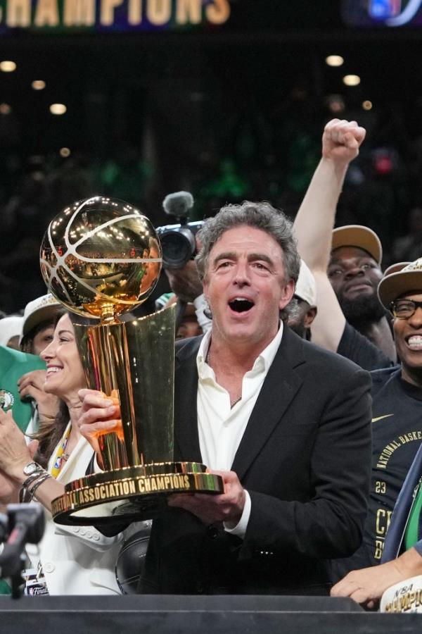 Wyc Grousbeck holds the championsip trophy after the Celtics win the title.
