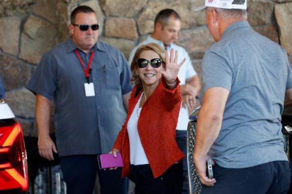 Shari Ellin Redstone, President of National Amusements, waving as she arrives at the Allen & Co. Sun Valley Conference in Sun Valley, Idaho, with others in the background