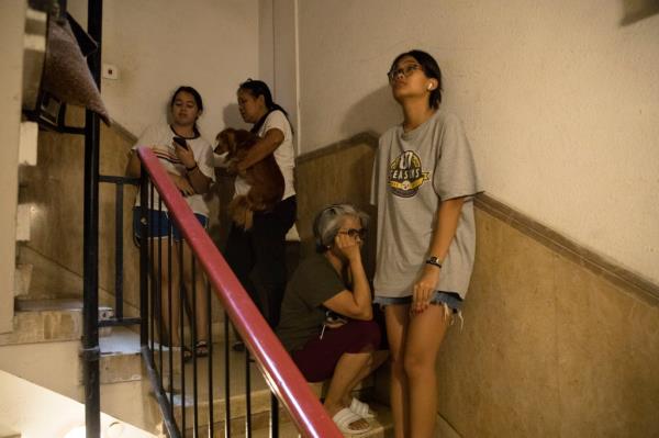 A photo of Israeli citizens cowering in a stairwell during the Hamas attack.