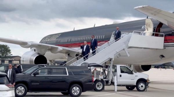 Republican presidential candidate and former U.S. President Donald Trump gestures as he arrives at Milwaukee Mitchell International Airport a day after he survived an assassination attempt at a rally in Butler, Pennsylvania, in Milwaukee, Wisconsin, U.S., July 14, 2024 in this screengrab obtained from a social media video.