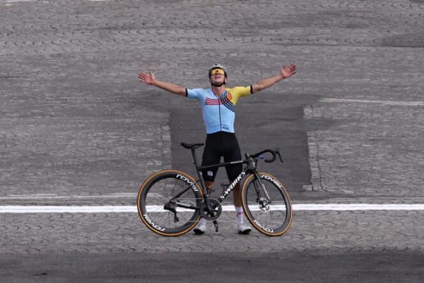 Belgium's Remco Evenepoel celebrates as he crosses the finish line to win the men's cycling road race during the Paris 2024 Olympic Games in Paris, on August 3, 2024.
