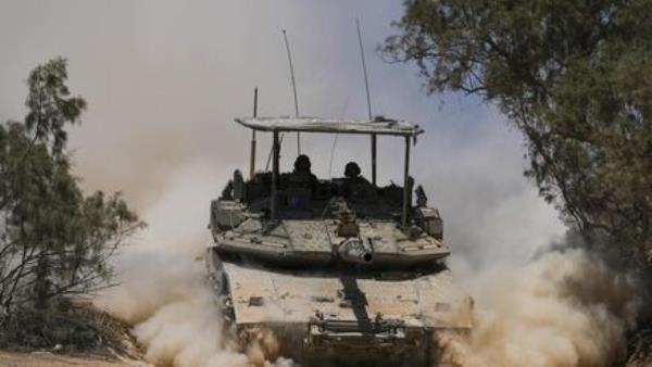 Israeli soldiers drive a tank near the Israeli-Gaza border, in southern Israel, on Wednesday. Picture: Tsafrir Abayov/AP Israeli soldiers drive a tank near the Israeli-Gaza border, in southern Israel, on Wednesday. Picture: Tsafrir Abayov/AP
