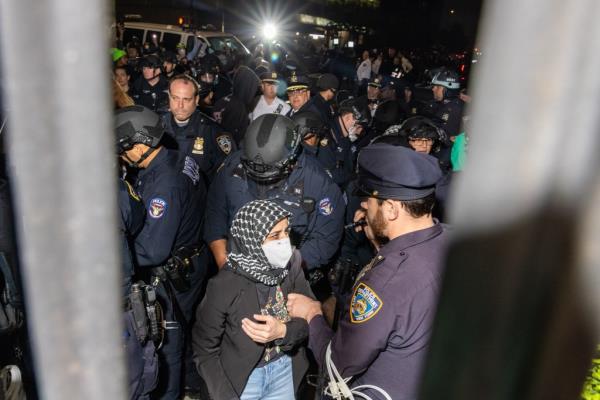 Members of the NYPD arrest protesters blocking the entrance to Columbia University while clearing the pro-Palestinian protest encampment and Hamilton Hall where demonstrators barricaded themselves inside on April 30, 2024 in New York City.