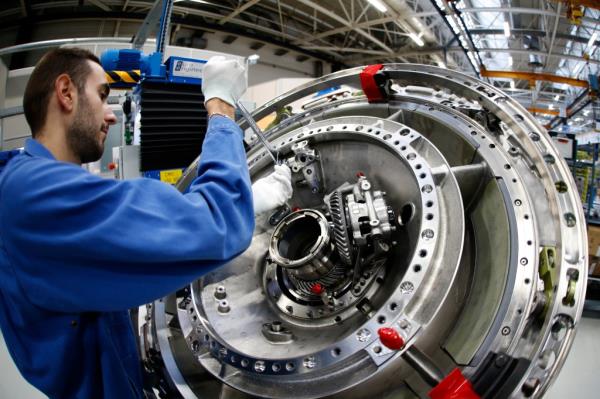 A technician works on an CFM56 civil aviation jet engine.