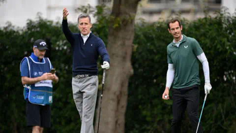 Getty Images Anton Du Beke and Sir Andy Murray place golf on an overcast day.