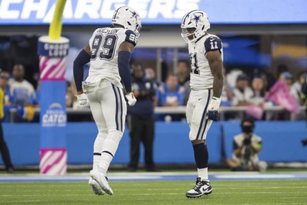 Dallas Cowboys defensive end Chauncey Golston and linebacker Micah Parsons celebrate Parsons' sack.