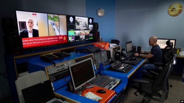 FILE - Al Jazeera broadcast engineer Mohammad Salameh works at the Master Control Room unit inside the network's office in the West Bank city of Ramallah, May 5, 2024. 