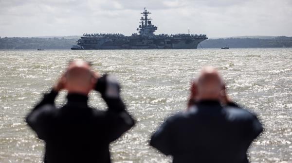 Sailors looking at ship with binoculars