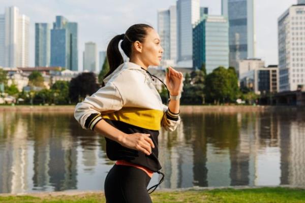 woman power walking by water