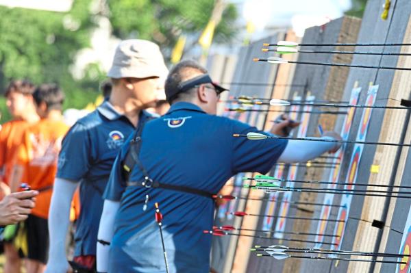 Recurve archers from the Master’s division marking their target papers after taking scores.