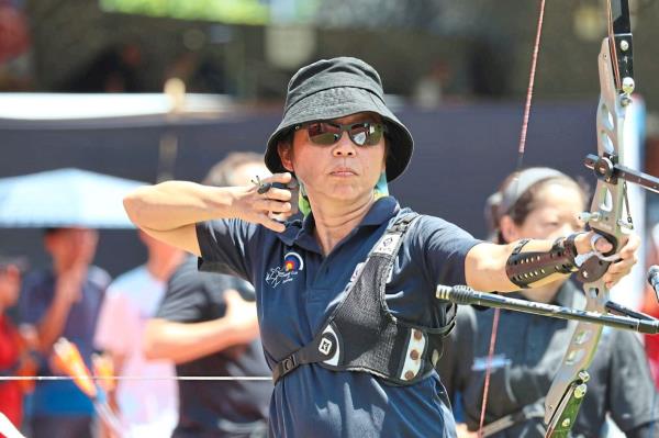 An archer executing her shot at the Master’s recurve team event.