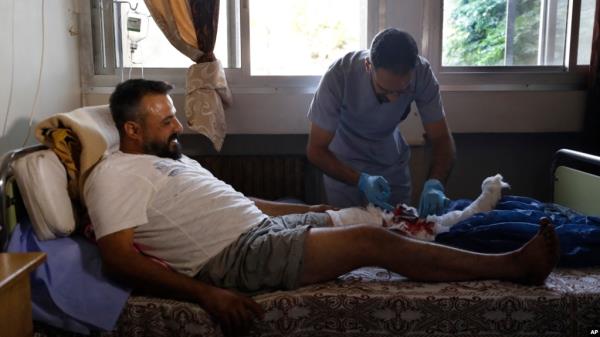 A nurse treats a man who was injured in an Israeli strike in Masyaf, Syria, on Sept. 9, 2024. U.N. officials say unrest related to Israel's fight against Hamas and Hezbollah is one of the factors imperiling the Syrian people.