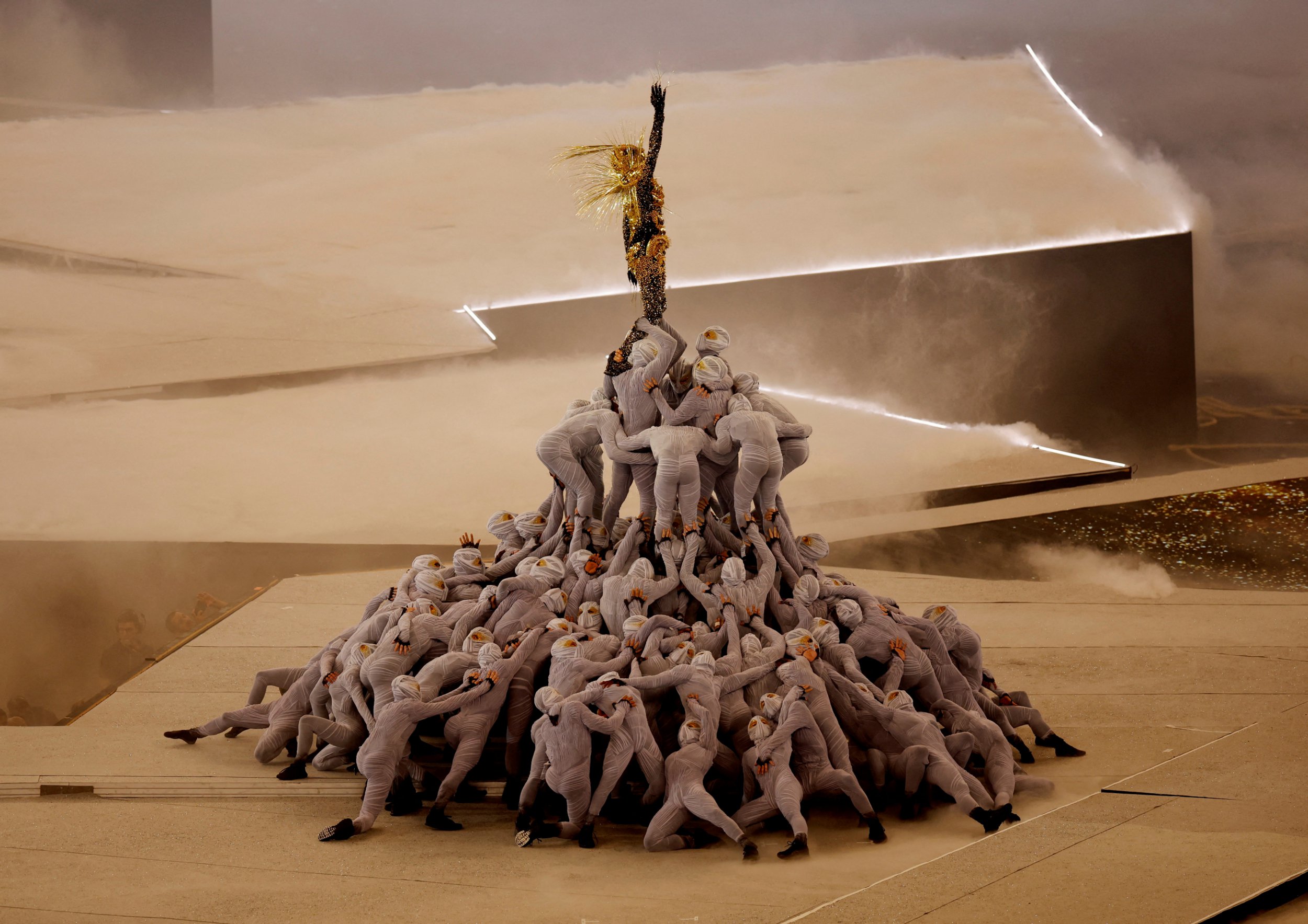 Paris 2024 Olympics - Ceremonies - Paris 2024 Closing Ceremony - Stade de France, Saint-Denis, France - August 11, 2024. The Golden Voyager stands atop a pile of masked dancers in a performance during the closing ceremony. REUTERS/Anushree Fadnavis TPX IMAGES OF THE DAY