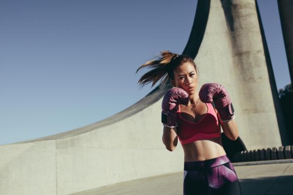 Woman kickboxing, strip away stress