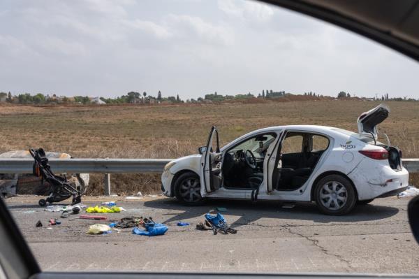 A photo of a damaged car and baby stroller on the Gaza border.