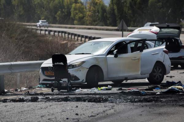 Cars and a stroller left behind at the scene of a rocket attack from Gaza on the weekend are pictured on a main road near the entrance of the Israeli kibbutz of Kfar Aza on the border with the Gaza Strip, on October 10, 2023.