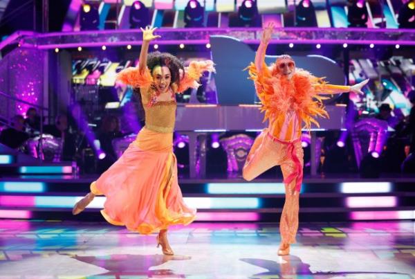 Jamie Borthwick and Michelle Tsiakkas in orange outfits performing on Strictly