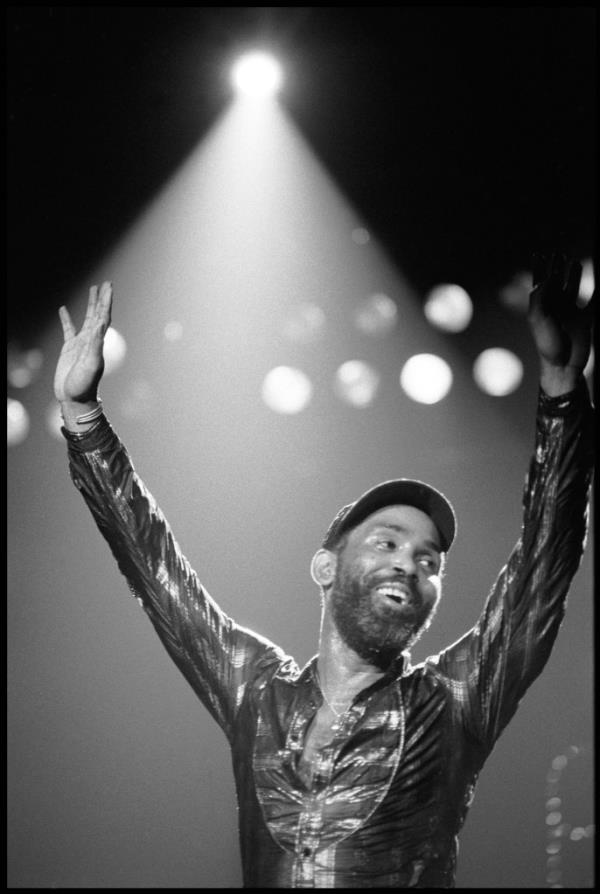 Frankie Beverly performing onstage. 