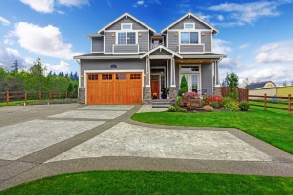 house exterior with a large, paved driveway