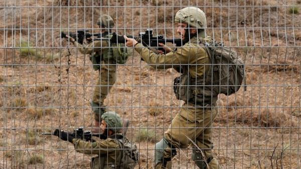 Israeli soldiers scan an area while sirens sound as rockets from Gaza are launched towards Israel, near Sderot, southern Israel, October 9, 2023. REUTERS/Amir Cohen