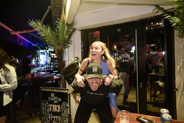 Luke Timm giving a customer a piggy back ride