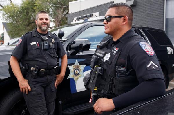 Arapahoe County Sheriff's Deputy Christopher Calderon  standing next to his lieutenant, Darren Gammel.