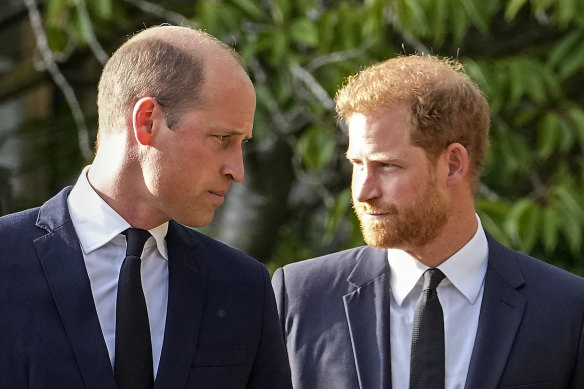 Prince William and Prince Harry walk beside each other after viewing the floral tributes for the late Queen Elizabeth II outside Windsor Castle, in Windsor, England in 2022.