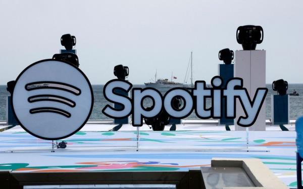 Spotify reports strong user growth, raises prices